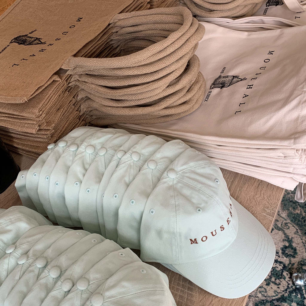 a large order for a corporate client, including mint green caps, shoppers and totes - all with custom embroidered branding.